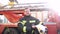 Fireman putting off helmet after work standing near a truck