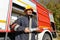 Fireman stands in front of a fire truck