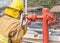 Fireman in yellow fire fighter uniform during connect firehose tube in to fire hydrant