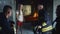 Firemen interrogating saved girl in burning building