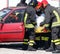 Firemen pull the injured from the car after the car accident