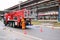 Firemen rescue workers in fireproof suits came to extinguish a fire in a fire truck and stretch the hoses in a large industrial