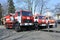 Firemen standing near fire trucks before training