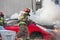 Firemen training on a burning car