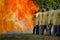 Firemen using water from hose for fire fighting at fire fight training of insurance group.Firefighter wearing a fire suit for