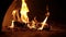 Fireplace burning in slow motion. Warm cozy burning fire in brick fireplace