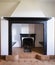 Fireplace detail in black marble and white walls