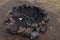 Fireplace fire pit hole in meadow forest campfire natural made of stones