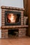 Fireplace with flame and glass door in comfort house