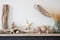 a fireplace mantel adorned with driftwood, starfish, and a sailors knot artwork