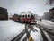 Firetruck driving out of the fire station in a snowy street