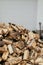 Firewood on background of house. Stack of firewood close up at farmhouse outdoor. Chopped wood for fireplace heating, alternative