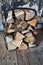 Firewood basket standing on wooden floor indoors