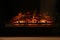 Firewood burning bright in elegant fireplace indoors, closeup