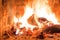 Firewood burning in fireplace fire heat red ashes interior