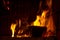 Firewood in flames and smoke of the fireplace background