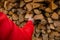 firewood.Heating season.Mens hands takes firewood from a woodpile .Woodpile and hands