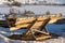 Firewood lumber leftovers on trestle at winter evening with selective focus