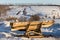 Firewood lumber leftovers on trestle at winter evening with selective focus