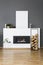 Firewood and silver table in front of fireplace in loft interior