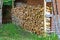 Firewood stored in front of a traditional wooden house