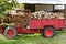 Firewood tractor in red color with stacked wood