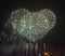 Firework  Bursts in Heart Shape against night Sky.