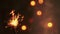 Firework sparkler burning on bokeh light background, congratulation greeting party happy new year, christmas celebration