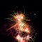 Firework streaks in night sky, celebration