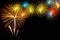 Fireworks on the black sky background with reflection on water a