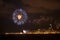 Fireworks with a coastal city in the background.