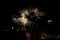 Fireworks display against buildings and dark sky in the city on New Year\\\'s Eve