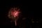 Fireworks display against buildings and dark sky in the city on New Year\\\'s Eve