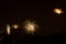 Fireworks display against buildings and dark sky in the city on New Year\\\'s Eve