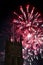 Fireworks display with a tower in the foreground