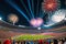 Fireworks Erupting in the Night Sky Above a Stadium Filled with Excited Spectators: Bursts of Color Illuminate the Celebration