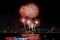 Fireworks explored over cityscape at night in sea port in Pattaya