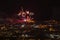 Fireworks over the night city of Brno in the Czech Republic in Europe. Above the city are different colored shapes of flares.