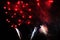 Fireworks. Salute. Sky background Amazing extravaganza of bright red shiny lights in the night sky during the New Year and