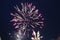 Fireworks salute white flashes lights rose white on a dark black background. Festive atmosphere New Year Christmas Independence