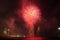 Fireworks on the water seen from the beach, in Barcelona