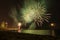 Fireworks on the water seen from the beach, in Barcelona