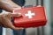 Firm grasp, Young man\\\'s hand holding a first aid kit