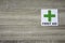 First aid sign on the wooden wall with space for adding text on the left side