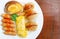 First Breakfast with Sausage, bread,egg on white plate in the morning time,close-up view.