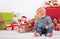 First Christmas: baby unwrapping a present - happy family - children eyes