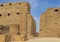 First courtyard side of the first pylon and ruins of the kiosk of Taharqa in the Temple of Amun at Karnak in Luxor, Egypt.