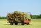 First cutting square hay bales in red hay wagon