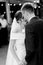 The first dance of the newlyweds in front of the guests. Black and white photo