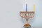 First day of Hanukkah with burning Hanukkah colorful candles in Menorah traditional Candelabra